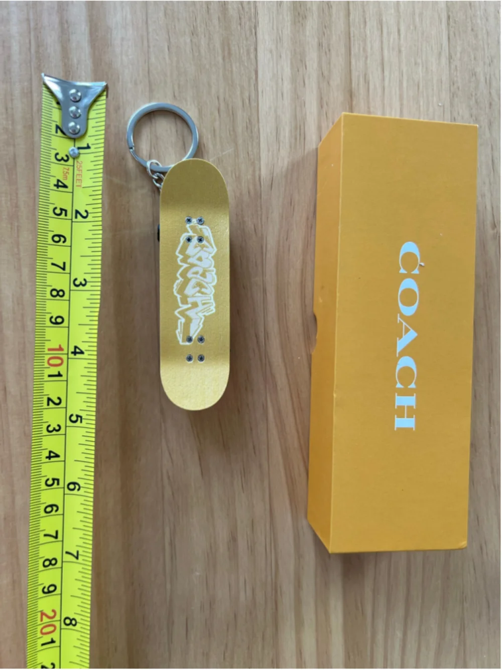 RARE Coach 2023 Limited Yellow Finger Skateboard Graffiti Keychain Sanya Popup